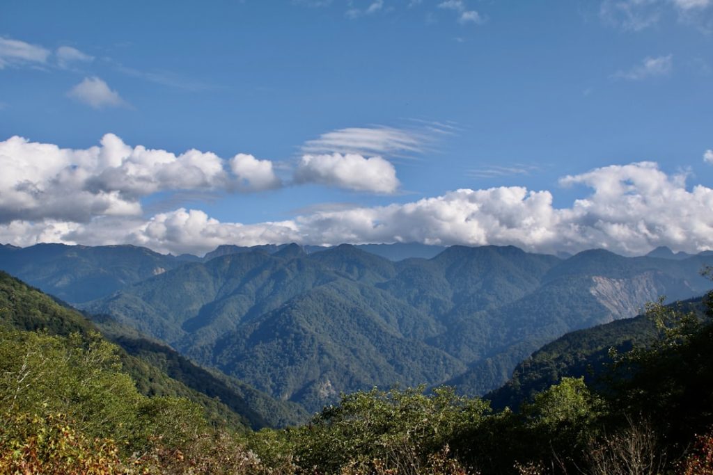 a view of a mountain range with clouds in the sky ffm0 tx5tzg.jpeg